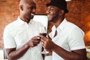 Two guys holding wine